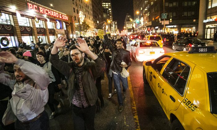 New Yorkers protest in Manhattan on Nov. 25, 2014, the day after a grand jury decision in Ferguson, Mo., not to indict a police officer who fatally shot unarmed teenager Michael Brown. (Samira Bouaou/Epoch Times)