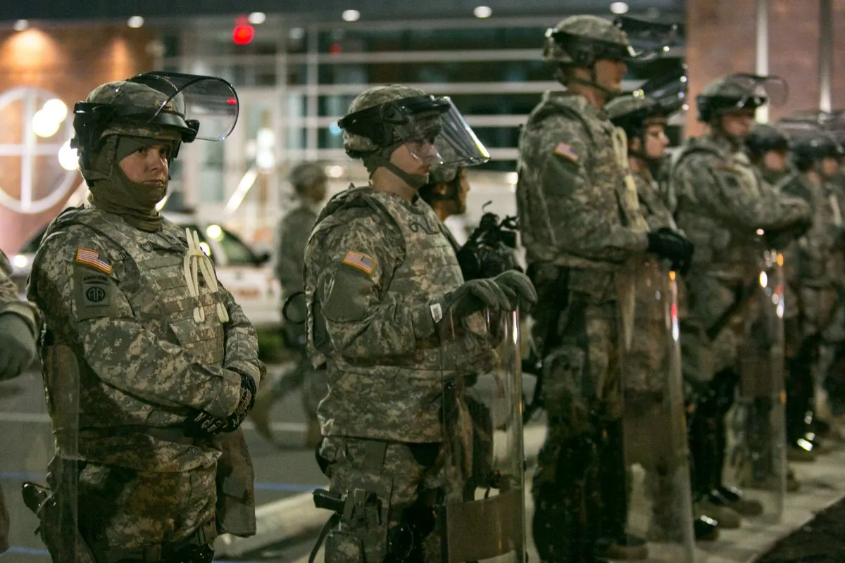 The National Guard stands by after protesters set fires and fired gun shots the night before in Ferguson, Mo., on Tuesday, Nov. 25, 2014. (Benjamin Chasteen/Epoch Times)