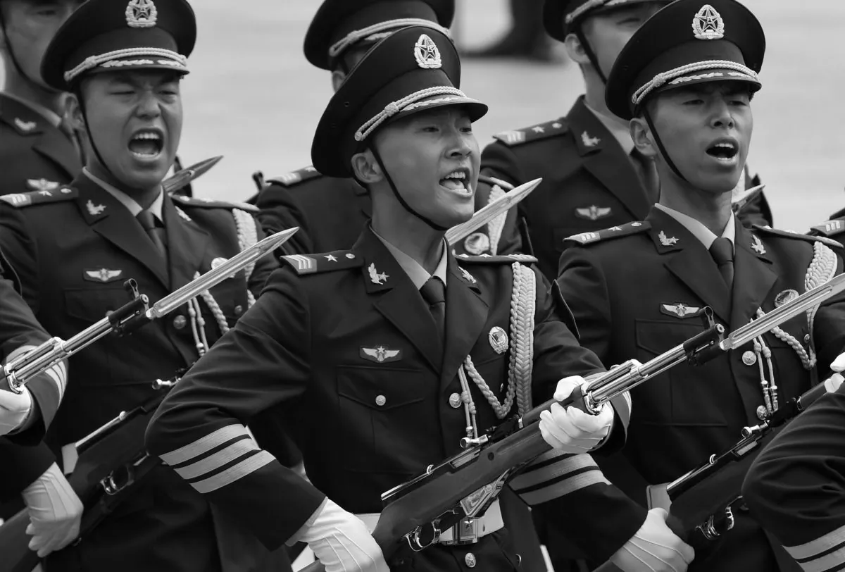 Chinese soldiers shout as they parade in Beijing on July 7, 2014. A debate has broken out inside China's military about whether it should strictly serve the Chinese Communist Party or serve the nation. (Greg Baker/AFP/Getty Images)
