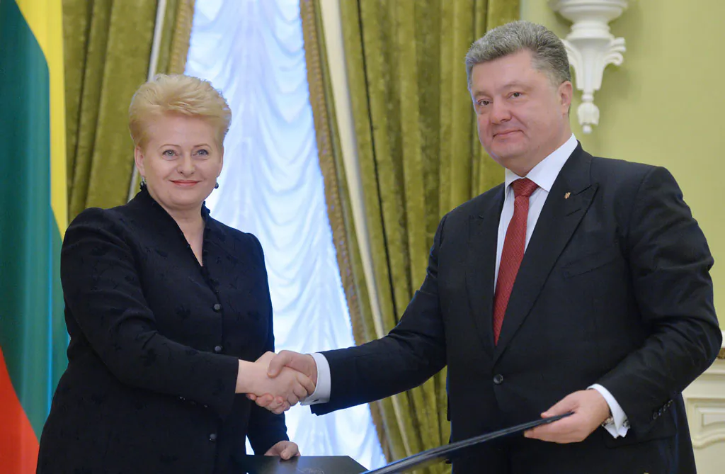 Lithuanian President Dalia Grybauskaite (L) and Ukrainian President Petro Poroshenko (R) shake hands after signing bilateral documents during their meeting in Kiev on Nov. 24, 2014. Grybauskaite promised military assistance for Ukraine as she slammed Russia's alleged 'terrorist' interference in a separatist insurgency in eastern Ukraine. Grybauskaite, one of Ukraine's strongest backers in its bid for closer ties with the West, promised that the Baltic state would use 'all support available' to help Ukraine militarily at a meeting with President Petro Poroshenko in Kiev. (Genya Savilov/AFP/Getty Images)