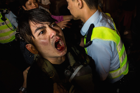 Riot police retain a man during clash with protesters at Mong Kok on November 25, 2014 in Hong Kong. The Mong Kok protest site is scheduled for clearance by baliffs this week after Hong Kong's high court authorized police to arrest protesters who obstruct bailiffs on the three interim restraining orders. (Lam Yik Fei/Getty Images)