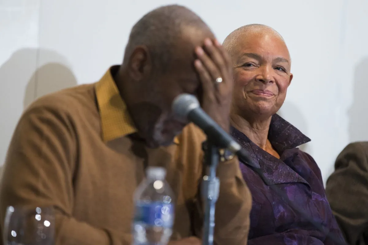 In this photo taken Nov. 6, 2014, Camille Cosby watches her husband Bill Cosby pause during a news conference about the upcoming exhibit, Conversations: African and African-American Artworks in Dialogue at the Smithsonian's National Museum of African Art in Washington. (AP Photo/Evan Vucci)
