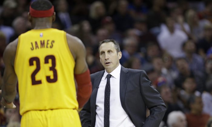 Cleveland Cavaliers head coach David Blatt, right, talks with Cleveland Cavaliers' LeBron James during an NBA basketball game against the San Antonio Spurs Wednesday, Nov. 19, 2014, in Cleveland. (AP Photo/Tony Dejak)