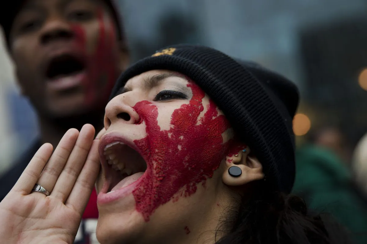 Protesters demonstrate on the day after the announcement that a grand jury decided not to indict Ferguson police officer Darren Wilson in the fatal shooting of Michael Brown, an unarmed 18-year-old, Tuesday, Nov. 25, 2014, in Philadelphia. (AP Photo/Matt Rourke)