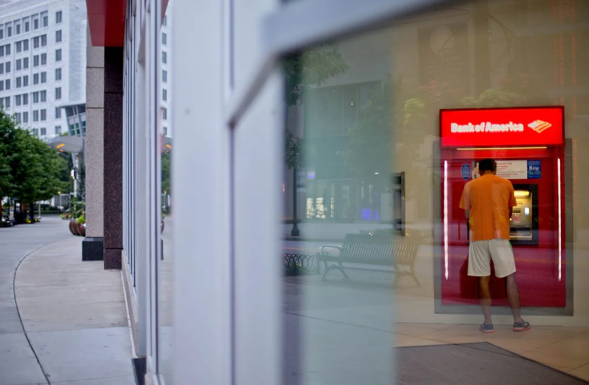 A customer uses an ATM at a Bank of America branch on Peachtree Street, in Atlanta, on July 16, 2013. US bank earnings rose 7.3 percent in the July-Sept. quarter of 2014, from a year earlier, as banks reduced their expenses and continued to lend out more money, which helped drive up revenue. (AP Photo/David Goldman)