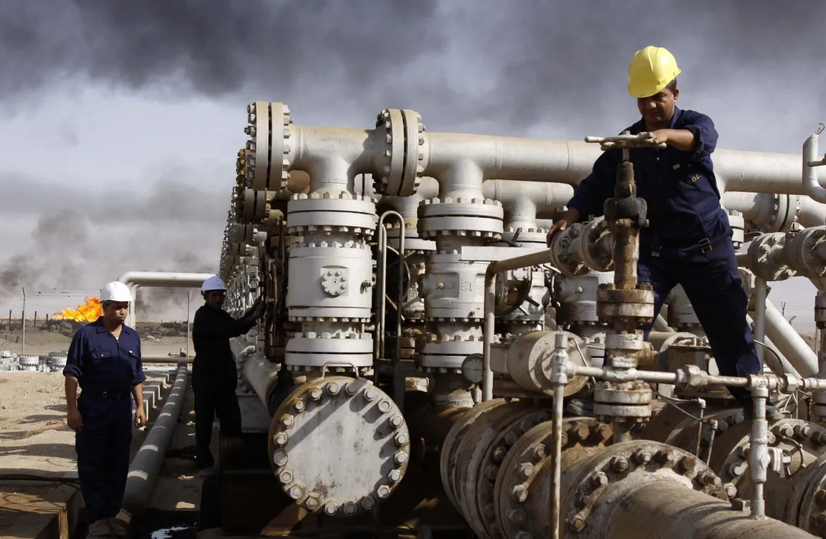 Oil personnel work at the Rumaila oil refinery, near the city of Basra, Iraq, on Dec. 13, 2009. (AP Photo/Nabil al-Jurani)