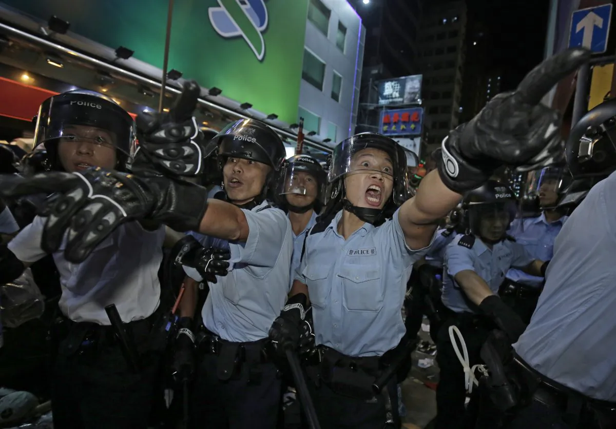 Police officers shout at protesters at an occupied area in Mong Kok district of Hong Kong on Tuesday. (AP Photo/Vincent Yu)