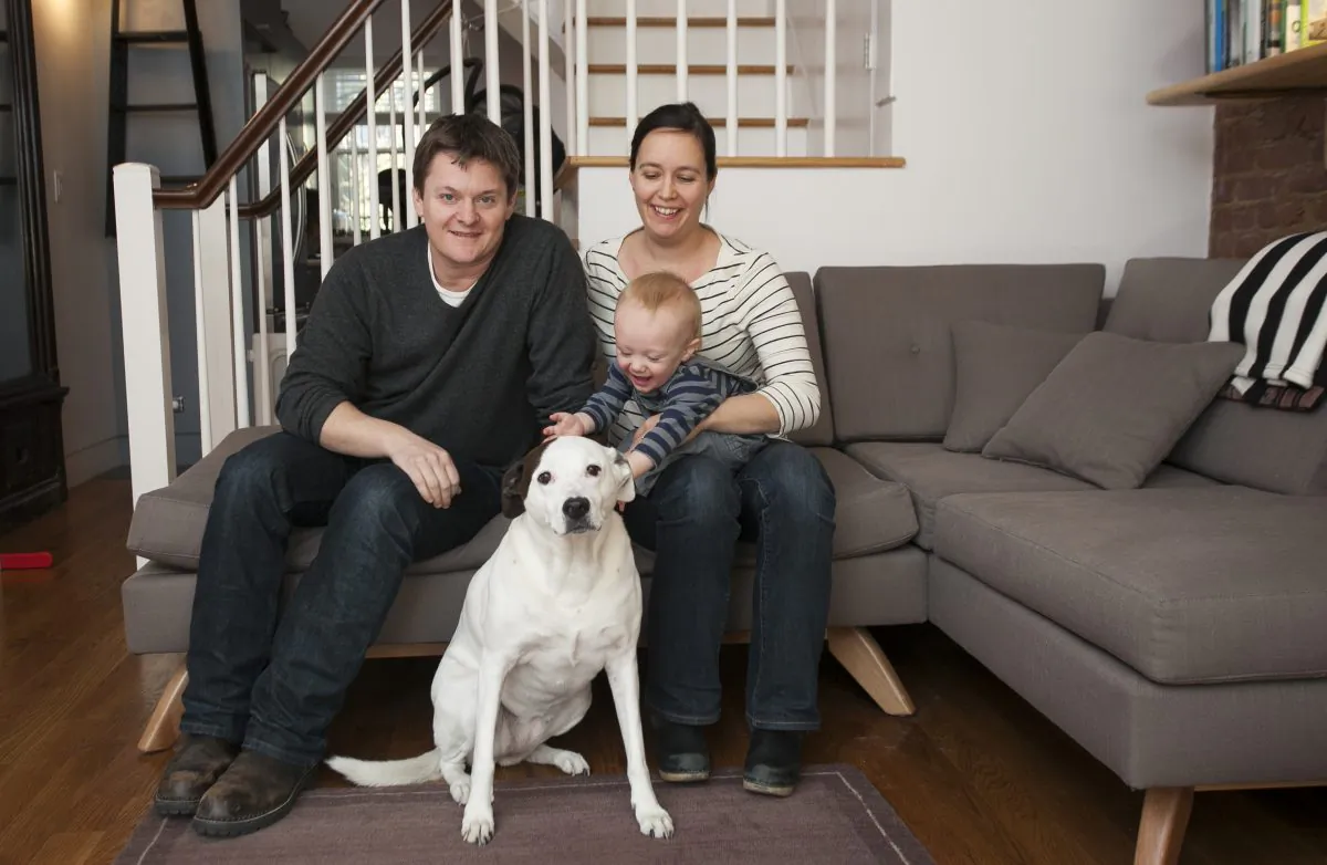 Architect Kyle Page, landscape architect Hardy Stecker, their son Otis Page, 11 months, and their dog Mazzy at their home in Clinton Hill, Brooklyn, on Nov. 21, 2014. (Samira Bouaou/Epoch Times)