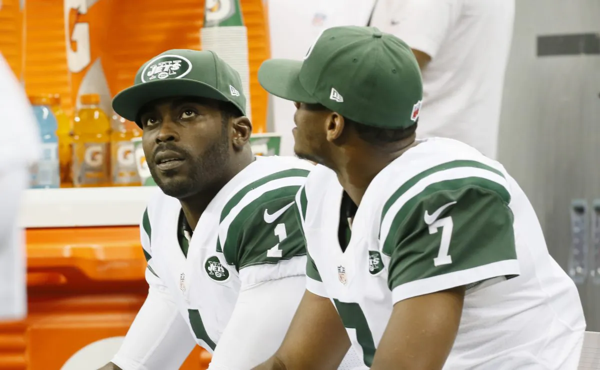 Michael Vick in a file photo along with Geno Smith. (AP Photo/Paul Sancya)