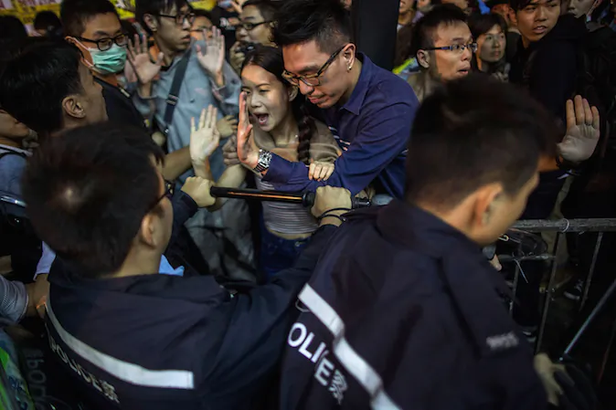 Pro-democracy protesters and pedestrians clash with police on a street in Mong Kok on November 26, 2014 in Hong Kong. (Lam Yik Fei/Getty Images)