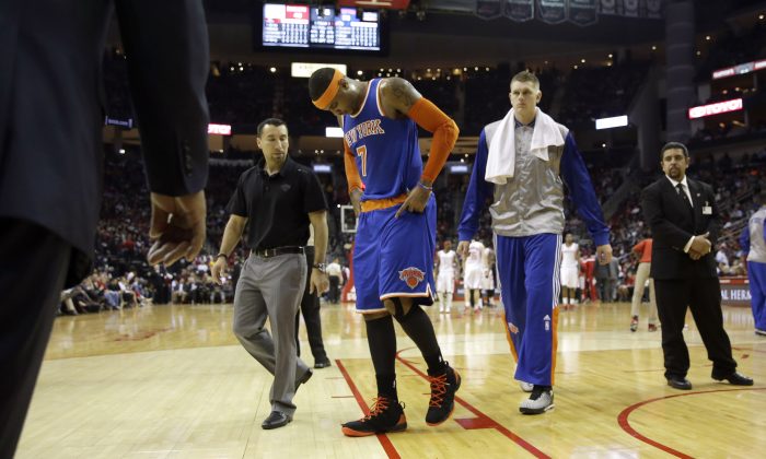 New York Knicks' Carmelo Anthony (7) leaves the court during the second quarter of an NBA basketball game against the Houston Rockets Monday, Nov. 24, 2014, in Houston. (AP Photo/David J. Phillip)