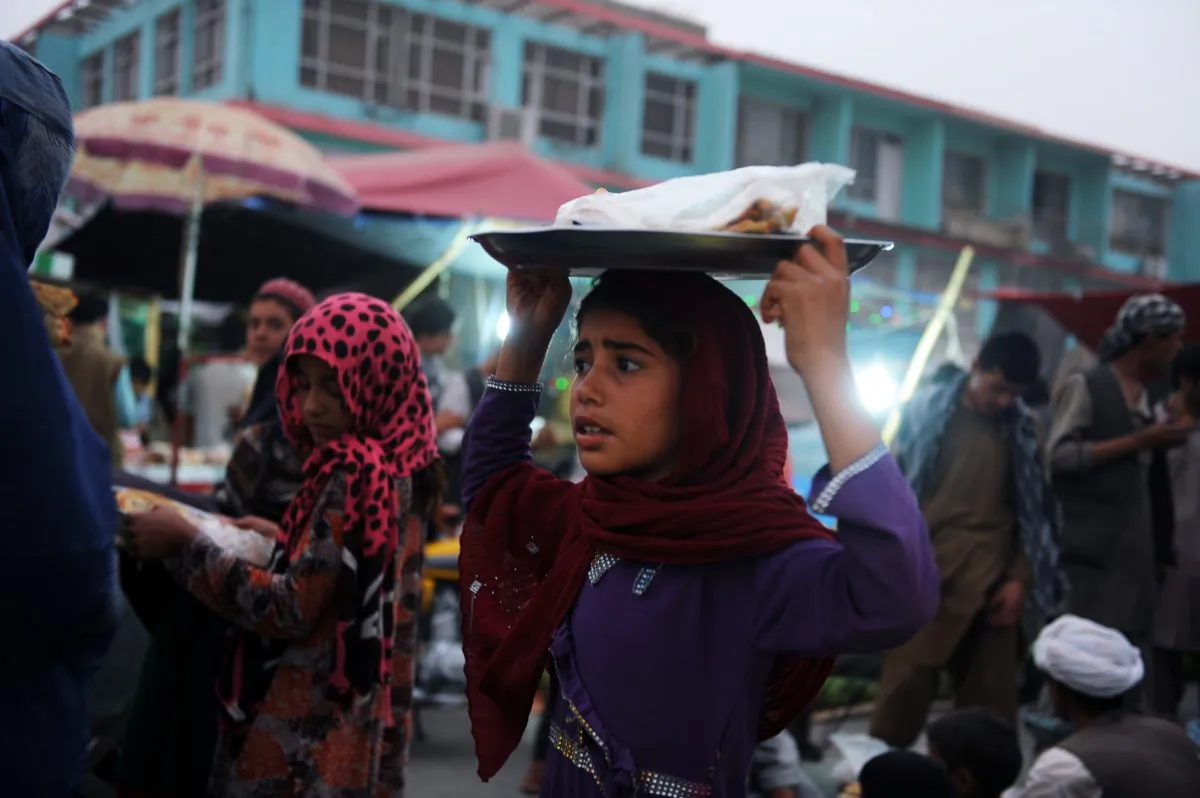 An Afghan girl sells a typical Afghan flat bread in the streets of Mazar-i-Sharif on July 1, 2014. (Farshad Usyan/AFP/Getty Images)