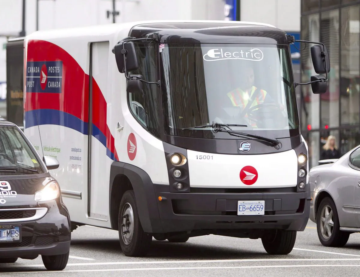 A Canada Post truck makes deliveries in Vancouver. The crown corporation is on track to make a profit in 2014 after a solid third quarter. (The Canadian Press/Jonathan Hayward)