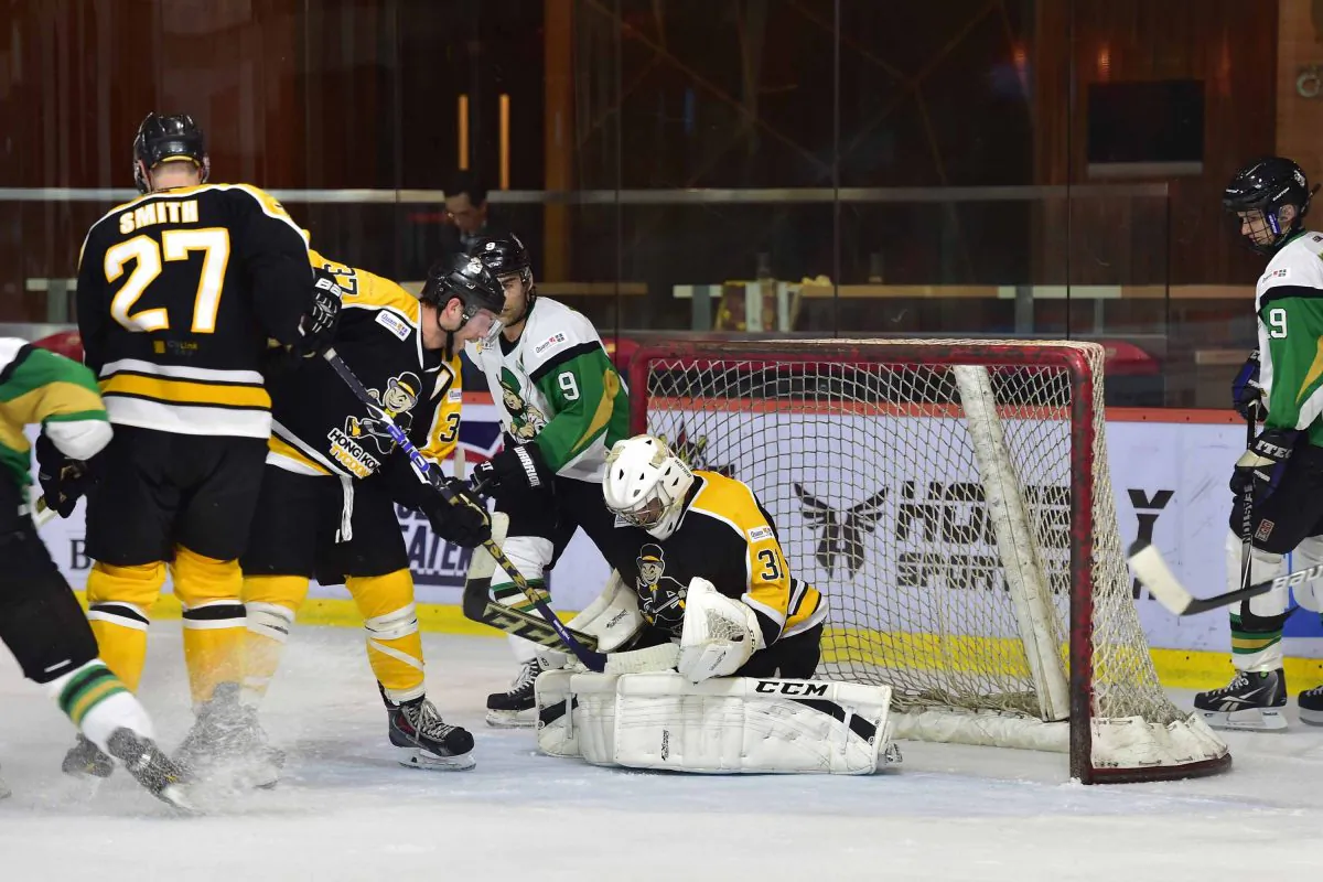 Hong Kong Tycoons goal scorers Brad Smith (27) and Kory Falite (37) back in defence to help goalie King Ho stave off an attack by the Macau Aces in the CIHL league at Mega Ice on Saturday Nov. 22, 2014. (Bill Cox/Epoch Times)