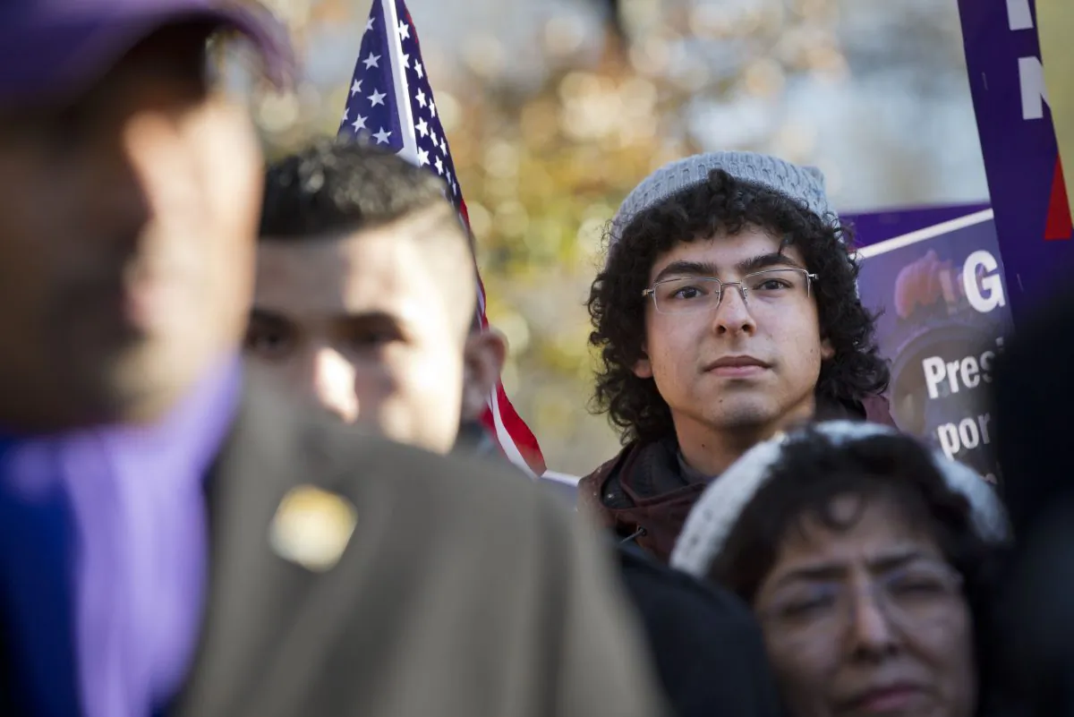 Daniel Nino, 20, who is originally from Colombia and qualified for the the DACA program, attends a rally in front of the White House in Washington, Friday, Nov. 21, 2014, with other supporters of immigration reform thanking President Obama for his executive action on illegal immigration. "My parents are not eligible under the executive action," says Nino, "I hope that Congress gets the guts to pass a comprehensive bill." (AP Photo/Jacquelyn Martin)