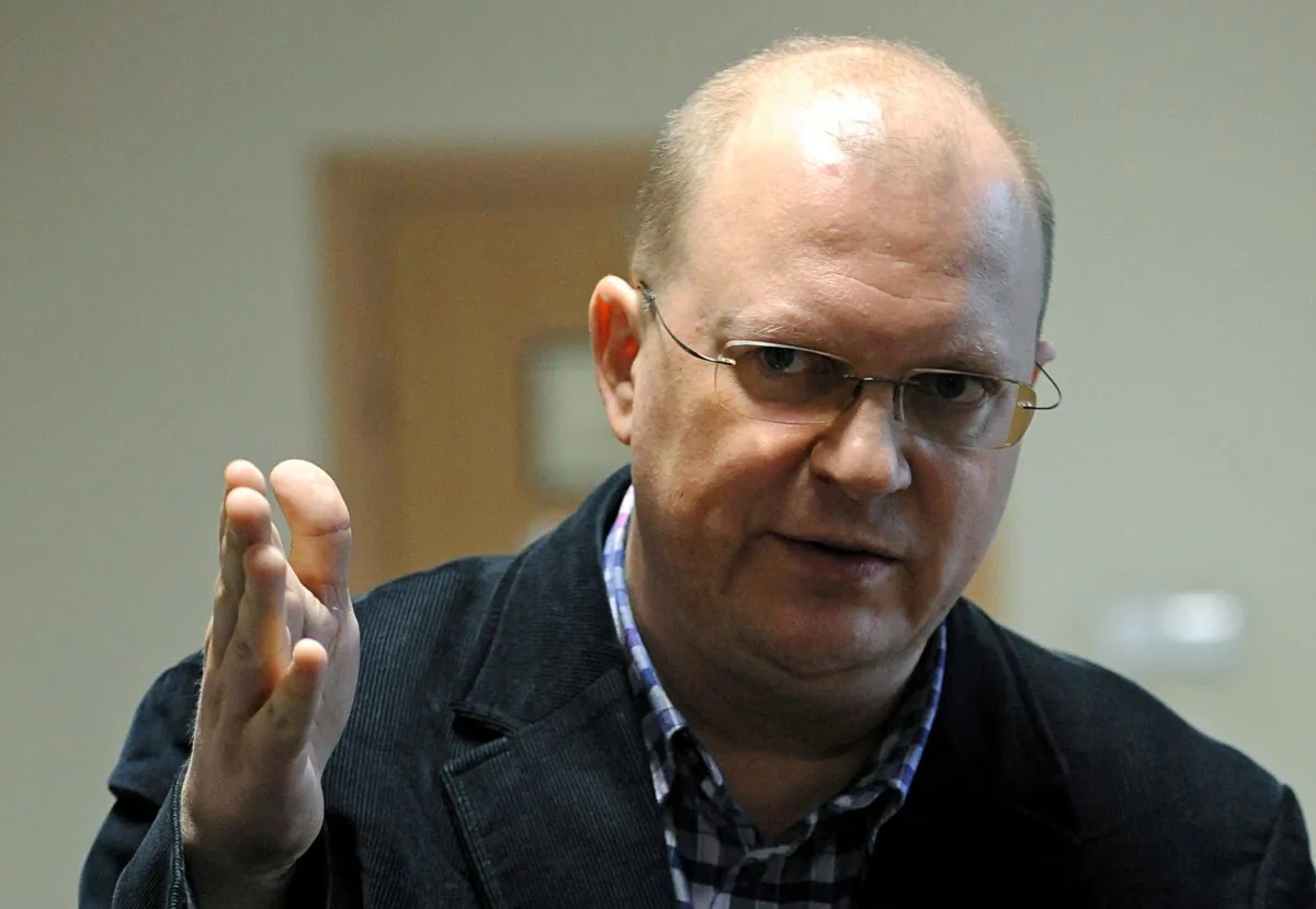 Russian journalist Leonid Sviridov speaks to the press after a three-hour meeting with officials concerning an attempt by Polish authorities to expel him from the country, in Warsaw, Poland, Wednesday, Nov. 26, 2014. Sviridov was stripped of his right to work as a journalist in Poland last month by the Foreign Ministry after Poland detained a top Polish Army official and a Polish-Russian lawyer on suspicion of spying. (AP Photo/Alik Keplicz)