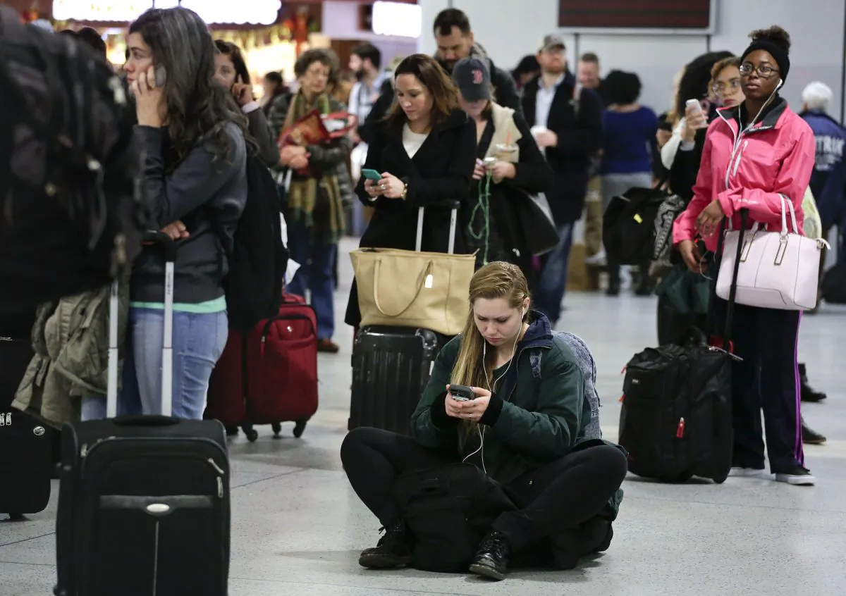 Thanksgiving holiday travelers at Penn Station in Manhattan, N.Y., on Wednesday, Nov. 26, 2014. One of the busiest, most stressful travel days of the year posed special challenges in the crowded Washington-to-Boston corridor as travelers on their way to Thanksgiving celebrations contended with a nor'easter packing rain and snow. (AP Photo/Julie Jacobson)