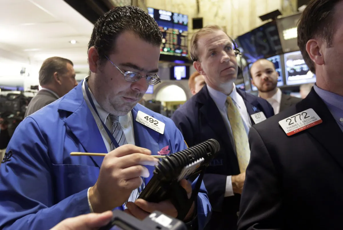 Traders Richard Scardino (L) and Michael Smyth work on the floor of the New York Stock Exchange, Wednesday, Nov. 26, 2014. Stock indexes are holding near record levels as traders digest some mixed news on the US economy. (AP Photo/Richard Drew)