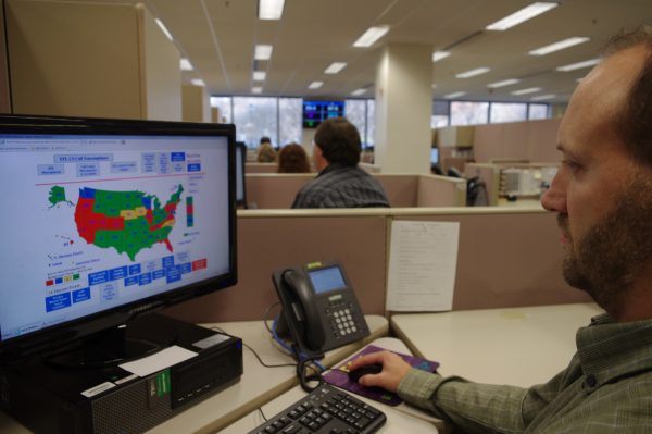 A researcher simulates a check done for the National Instant Criminal Background Check System or NICS, at the FBI’s criminal justice center in Bridgeport, W.Va., on Nov. 18, 2014. NICS did about 58,000 checks on a typical day in 2013. That surged to 145,000 on Black Friday. (AP Photo/Matt Stroud)