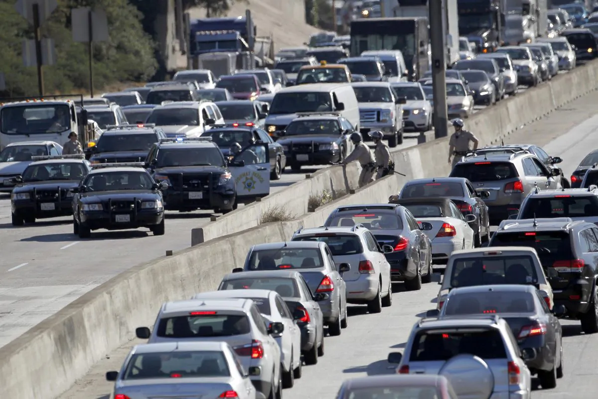 Los Angeles police officers stop traffic on the U.S. 101 near downtown Los Angeles after a small group of protesters, who sat down in a bus lane alongside the freeway, were arrested on Wednesday, Nov. 26, 2014. ince a grand jury's decision was announced Monday night, Nov. 24, not to indict a white Ferguson, Mo., police officer who killed Michael Brown, an unarmed black teen, protesters in cities throughout the country have rallied behind the refrain "hands up, don't shoot," and drawn attention to other police killings. Los Angeles Police Chief Charlie Beck says a total of nine people were arrested at the midmorning protest. (AP Photo/Nick Ut)