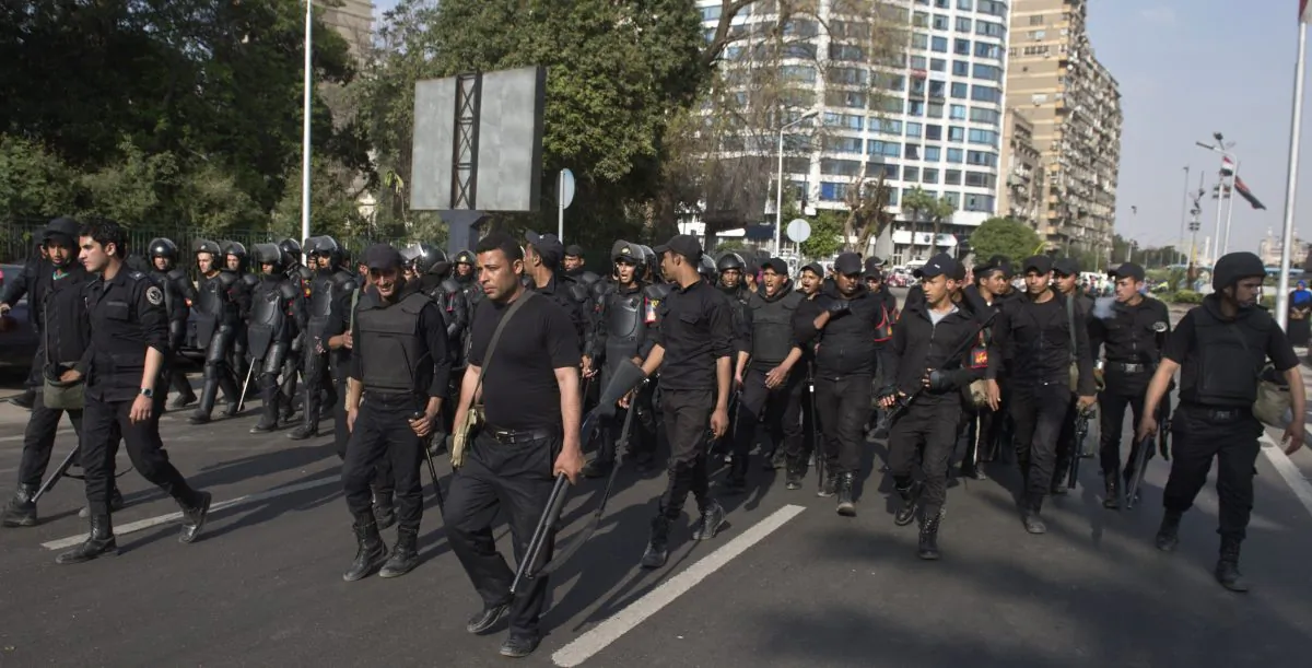 Egyptian riot policemen march forward along a street leading to the Cairo University on March 19, 2014, as clashes broke out during a protest by Muslim Brotherhood students, supporters of ousted president Mohamed Morsi. (Khaled Desouki/AFP/Getty Images)