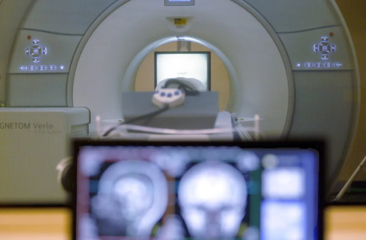 The brain-scanning MRI machine that was used at Carnegie Mellon University in Pittsburgh, for an experiment on tracking brain data is seen on campus Wednesday, Nov. 26, 2014. Volunteers where scanned as each word of a chapter of "Harry Potter and the Sorcerer's Stone" was flashed for half a second onto a screen inside the machine. Images showing combinations of data and graphics were collected. (AP Photo/Keith Srakocic)
