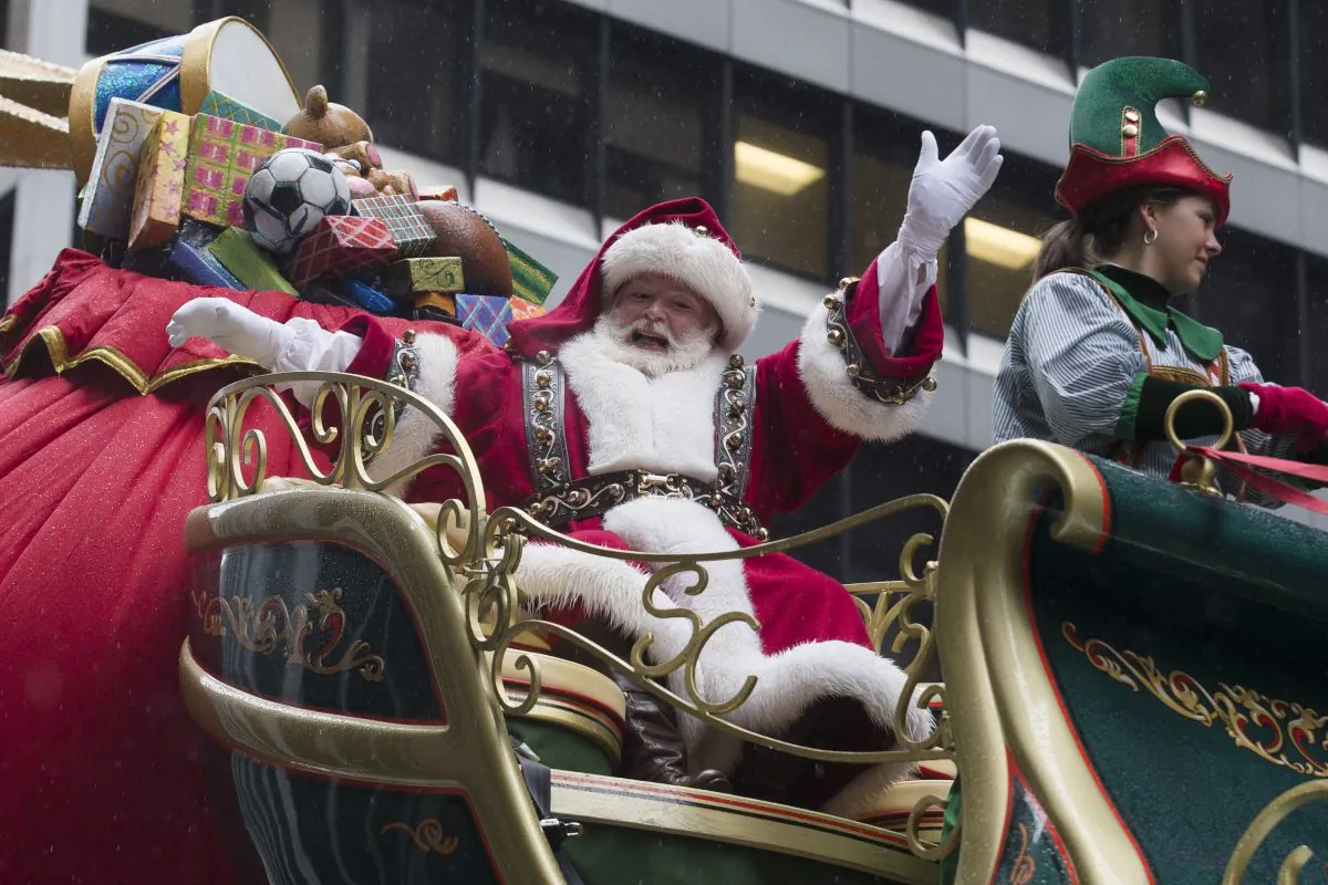 Santa Claus waves to spectators during the Macy's Thanksgiving Day Parade, Thursday, Nov. 27, 2014, in New York. (AP Photo/John Minchillo)