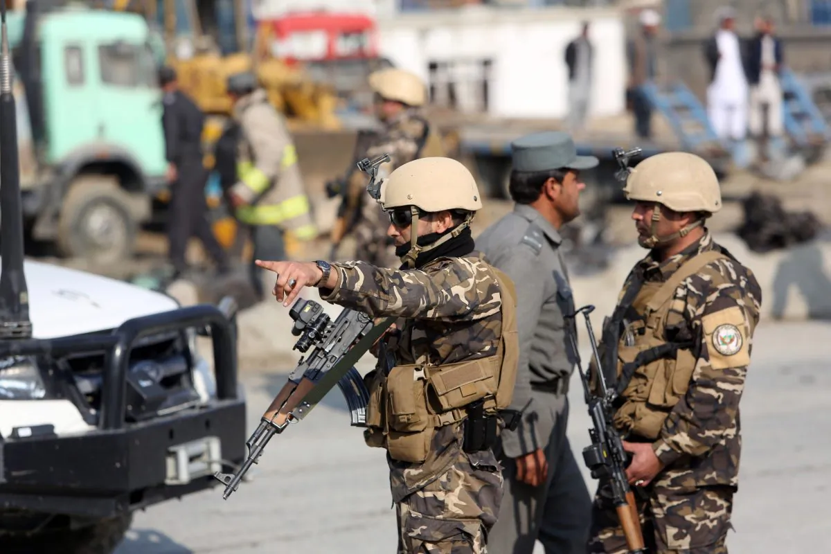 Afghan security forces inspect the site of a suicide attack in Kabul, Afghanistan, Thursday, Nov. 27, 2014. A suicide bomber attacked a British embassy vehicle in the Afghan capital Kabul on Thursday, killing several Afghan civilians and wounding more than 30 others, officials said. An embassy spokesman confirmed the attack and said some people in the vehicle were wounded, without providing further details. He added that the vehicle was not carrying any British diplomats. (AP Photo/Rahmat Gul)