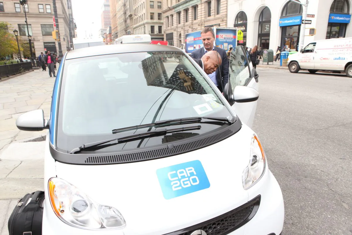 Brooklyn Borough President Eric Adams checks out Car2Go at Borough Hall with Bodo Uebber, Daimler AG board member, Nov. 2014. (Courtesy of Car2Go)