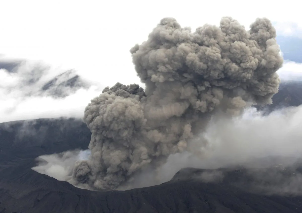 In this Nov. 26, 2014 photo, volcanic smoke billows from Mount Aso, Kumamoto prefecture, on the southern Japanese main island of Kyushu. The volcano is blasting out chunks of magma in the first such eruption in 22 years, causing flight cancellations and prompting warnings to stay away from its crater. The Japan Meteorological Agency said Friday, Nov. 28 that Mount Aso had spewed out lava debris and smoke, shooting plumes of ash a kilometer (3,280 feet) into the sky. The observatory does not expect the eruption to increase in scale. (AP Photo/Kyodo News) JAPAN OUT, MANDATORY CREDIT