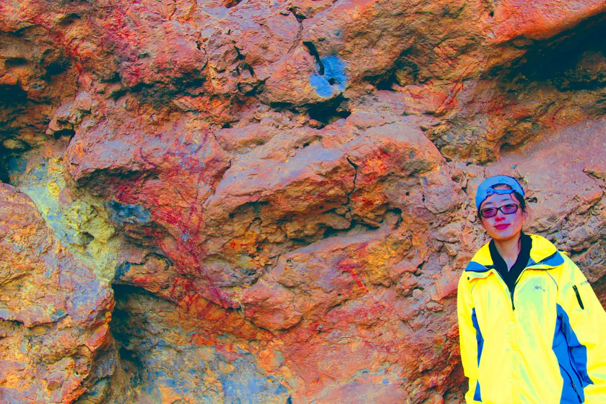 A bull from the Xianrendong rock art site (Yunnan, China) is a natural projection of stone that resembles a profile animal. It was painted with red ochre to highlight the head, front legs and side of the body. The head has a natural hole for an eye. The image was enhanced with DStretch (photo Paul Taçon).