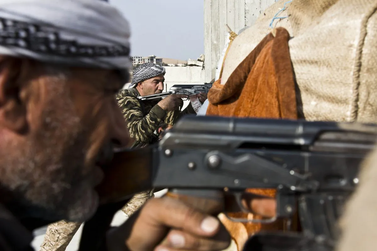 Fighters from the Free Syrian Army (L) and the Kurdish People's Protection Units (YPG) (C) join forces to fight Islamic State militants in Kobani, Syria, on Nov. 19, 2014. (AP Photo/Jake Simkin)