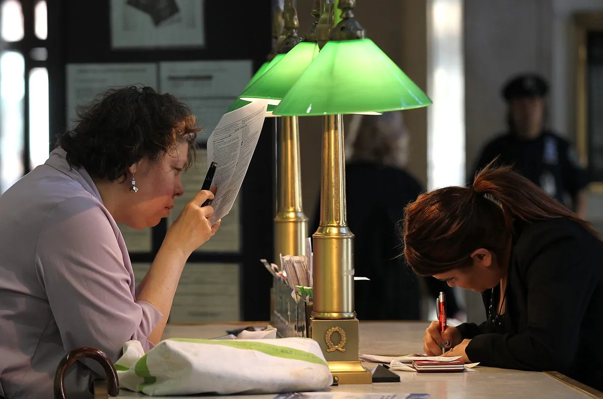 U.S. Postal Service customers go over tax documents at the James A. Farley Post Office in New York City on April 17, 2012. If you’re not in a high tax bracket, you can still make decisions to positively affect next year's tax return. 
(Justin Sullivan/Getty Images)