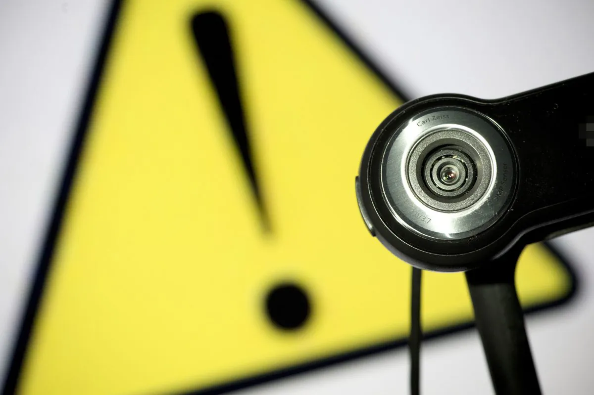 A webcam in front of a caution sign. (Lionel Bonaventure/AFP/Getty Images)