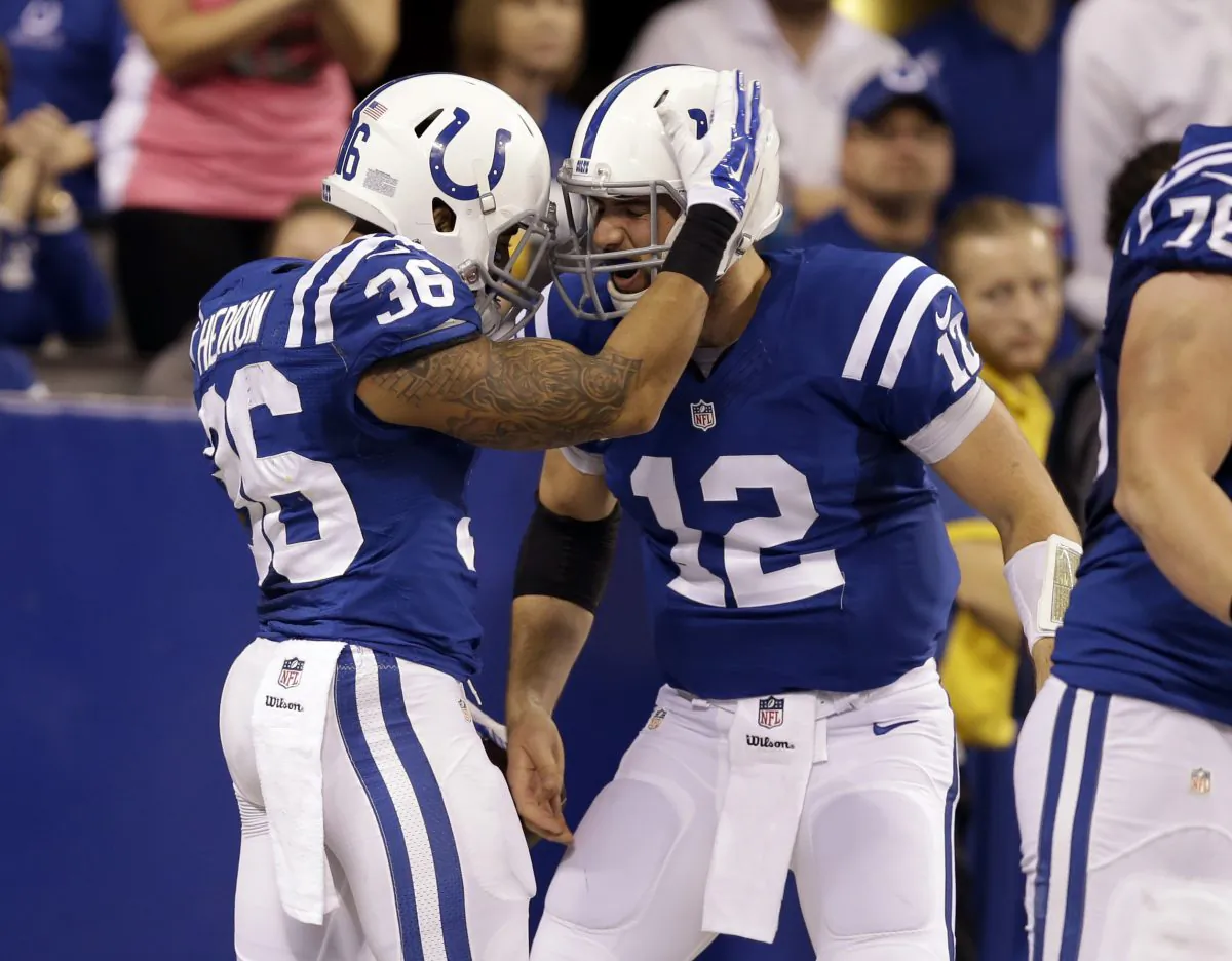 Indianapolis Colts running back Dan Herron, left, celebrates his 49-yard touchdown against the Washington Redskins with quarterback Andrew Luck during the first half of an NFL football game Sunday, Nov. 30, 2014, in Indianapolis. (AP Photo/Darron Cummings)