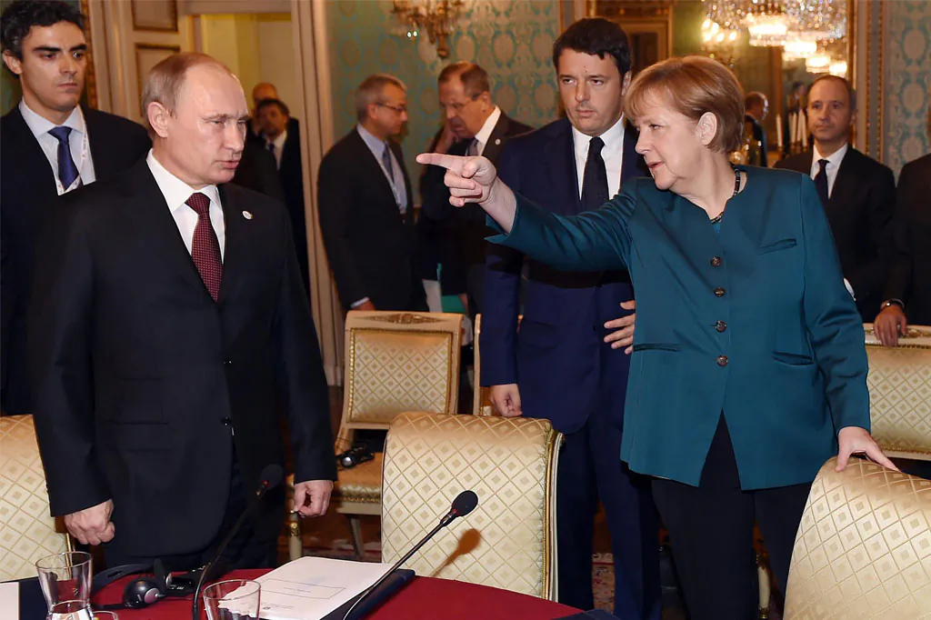German Chancellor Angela Merkel (R) speaks to Russia’s President Vladimir Putin (L) as Italian Prime Minister Matteo Renzi looks on prior to their meeting on Ukraine’s crisis with Ukrainian President Petro Poroshenko (not seen), on the sidelines of the 10th Asia–Europe Meeting (ASEM) summit in Milan on Oct. 17, 2014. (Daniel dal Zennaro/AFP/Getty Images)