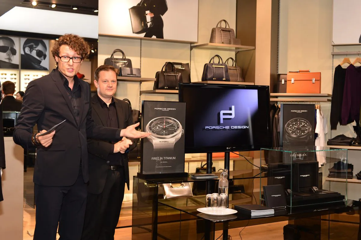 Marc Platten, COO Porsche Design (L), and Karsten Fried, Regional Manager, explain details of two new limited edition, Swiss made, chronograph models to potential customers at the watch launch at Porsche Design’s flagship boutique, 30 Queen’s Road, Central Hong Kong Nov. 19, 2014. (Bill Cox/Epoch Times)