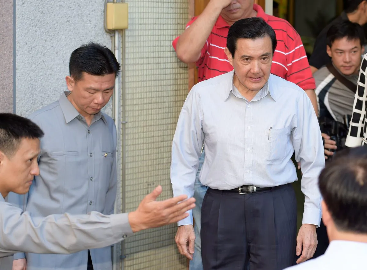 Taiwan President Ma Ying-jeou (2nd R leaves a polling station after voting in Taipei on Nov. 29, 2014. Unease about his pro-China policies contributed to the KMT's crushing electoral defeat in local races across the country (Sam Yeh/AFP/Getty Images)