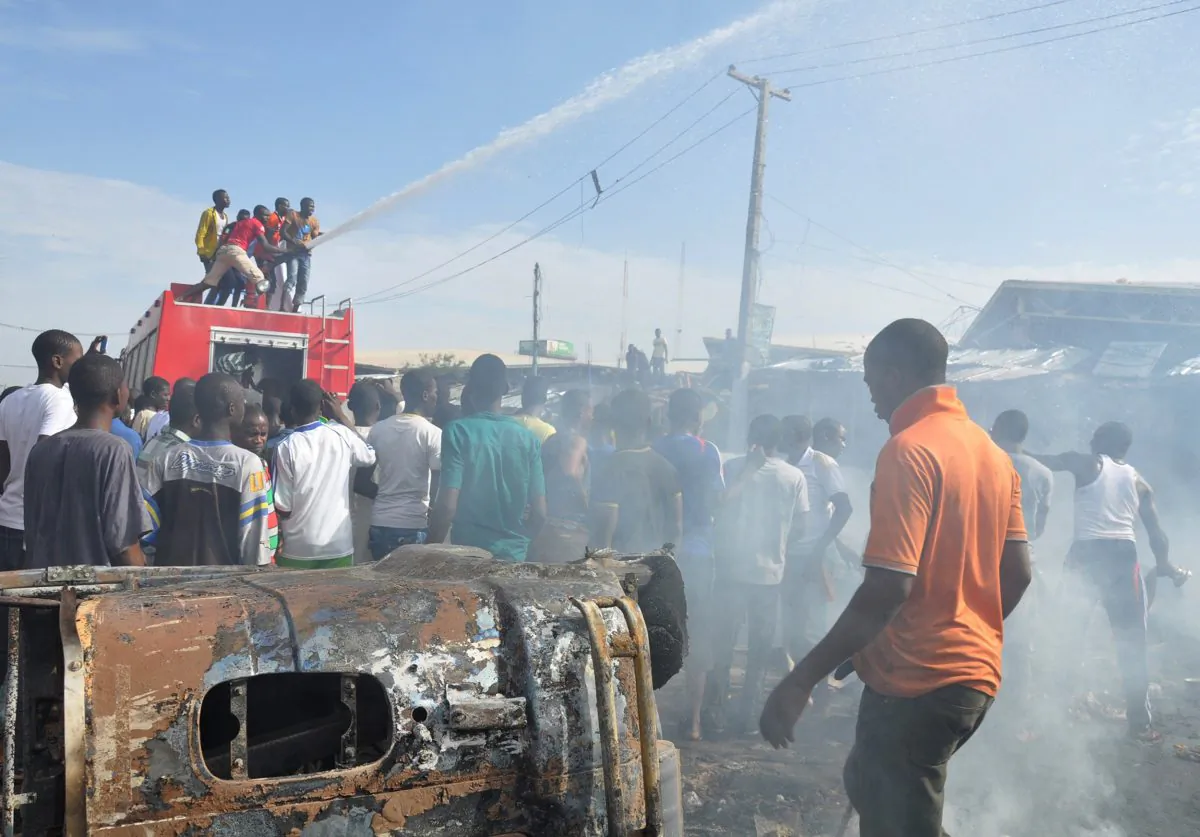 People gather at the scene of a car bomb explosion, at the central market, in Maiduguri, Nigeria. (AP Photo/Jossy Ola File)
