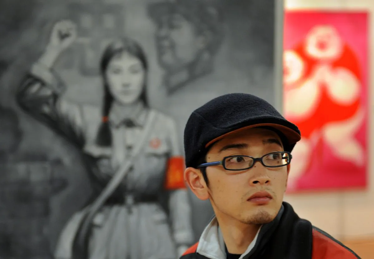 A Chinese man walks past a painting of a Red Guard from China's Cultural Revolution period at an art exhibit in Shanghai on April 17, 2008. (Mark Ralston/AFP/Getty Images)