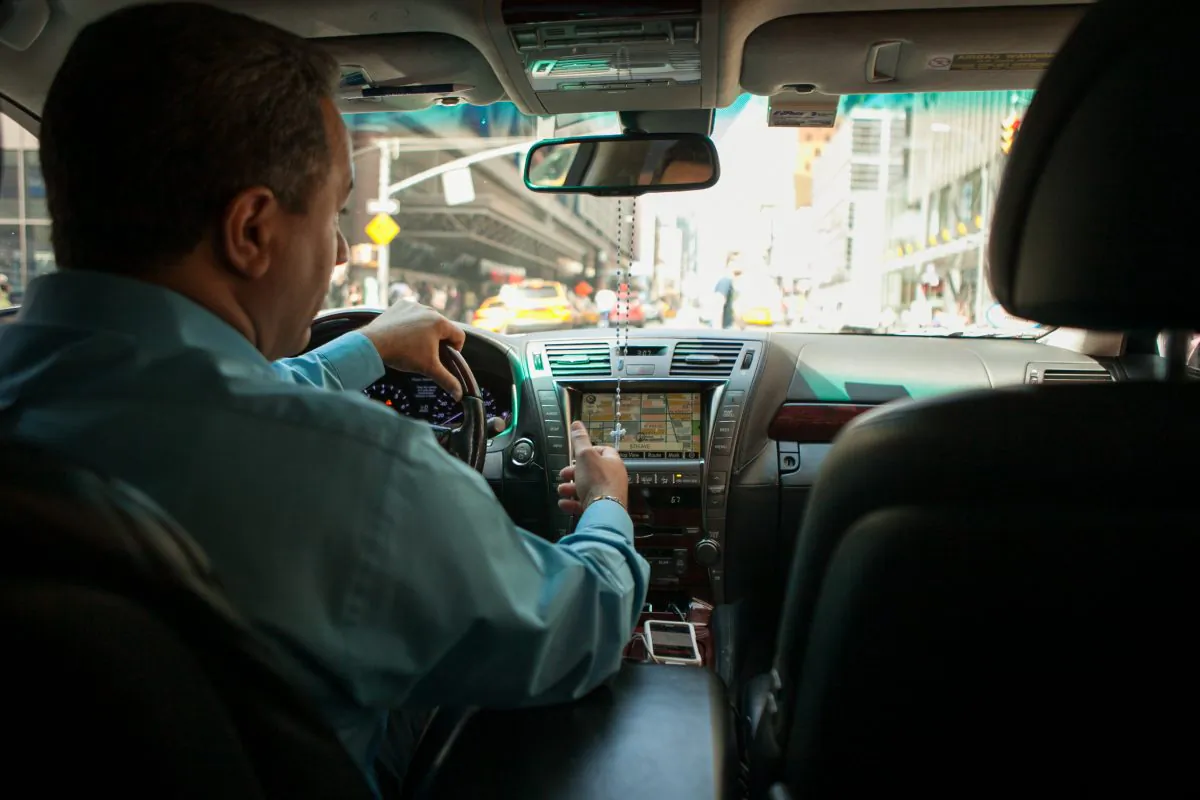 An Uber drives his car up Seventh Avenue in Manhattan on June 8, 2014. (Benjamin Chasteen/Epoch Times)
