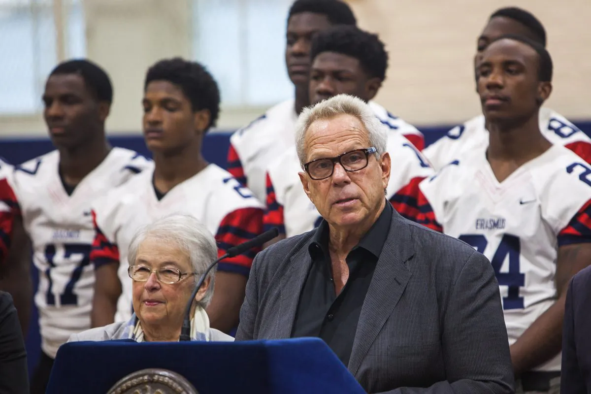 New York Giants chairman Steve Tisch announces his $1.2 million donation to New York City high school football at Erasmus Hall High School in Brooklyn, N.Y., on Dec. 2, 2014, while Schools Chancellor Carmen Fariña looks on. (Petr Svab/Epoch Times)