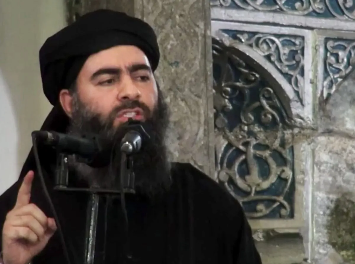 This file image made from video posted on a militant website Saturday, July 5, 2014, which has been authenticated based on its contents and other AP reporting, purports to show the leader of the Islamic State group, Abu Bakr al-Baghdadi, delivering a sermon at a mosque in Iraq. Lebanese authorities have detained a wife and son of the leader of the Islamic State group and she is being questioned, two senior Lebanese officials said Tuesday, Dec. 2, 2014. (AP Photo/Militant video)