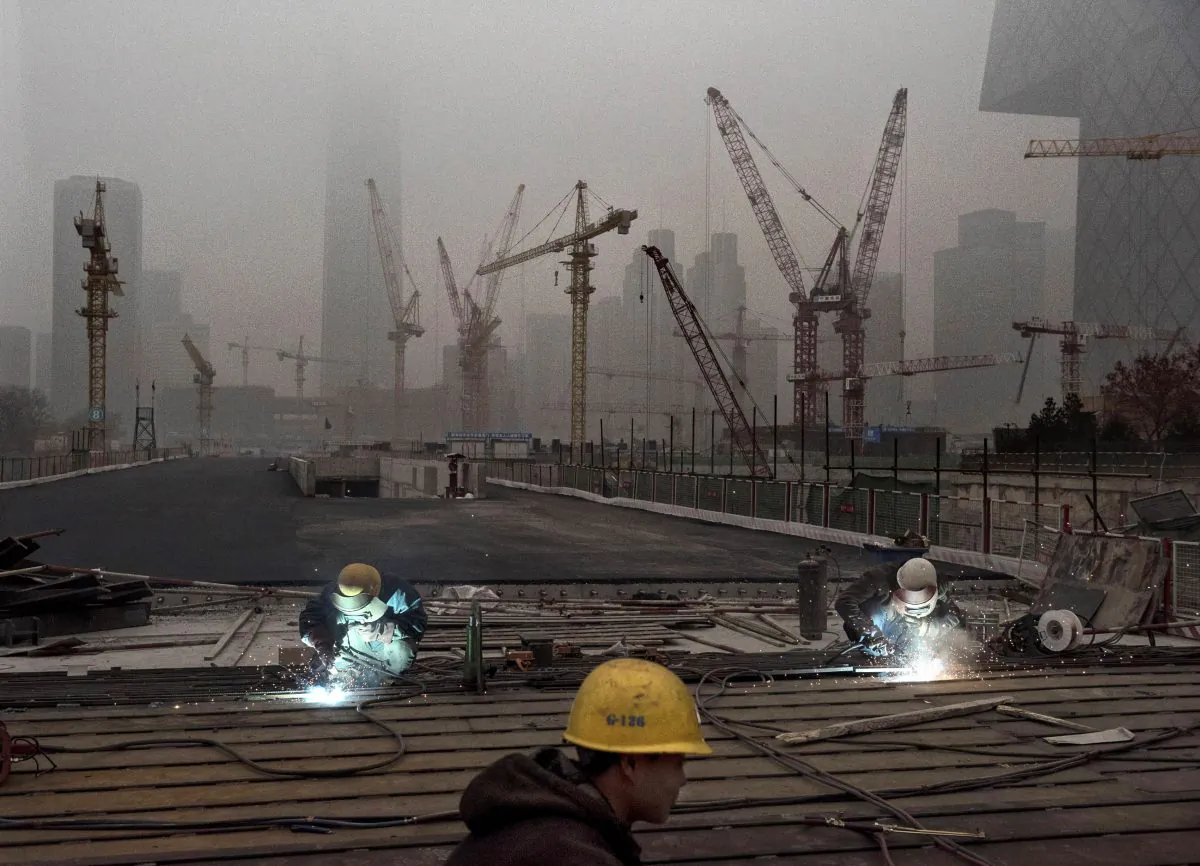 Chinese workers weld at a construction site in heavy pollution on Nov. 29, 2014, in Beijing, China. (Kevin Frayer/Getty Images)