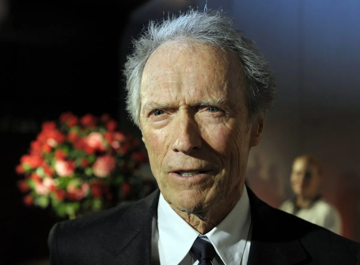 FILE - In this Feb. 1, 2012 file photo, actor and director Clint Eastwood speaks with reporters during the opening of the Warner Bros. Theater at the Smithsonian National Museum of American History in Washington. The National Board of Review thrust its support squarely behind the early 1980s New York drama “A Most Violent Year,” naming it best film and awarding its stars Oscar Isaac and Jessica Chastain. Announcing its annual selections on Tuesday, Dec. 2, 2014, the group also handed best director to Eastwood for his upcoming Navy SEAL drama “American Sniper.” (AP Photo/Cliff Owen, File)