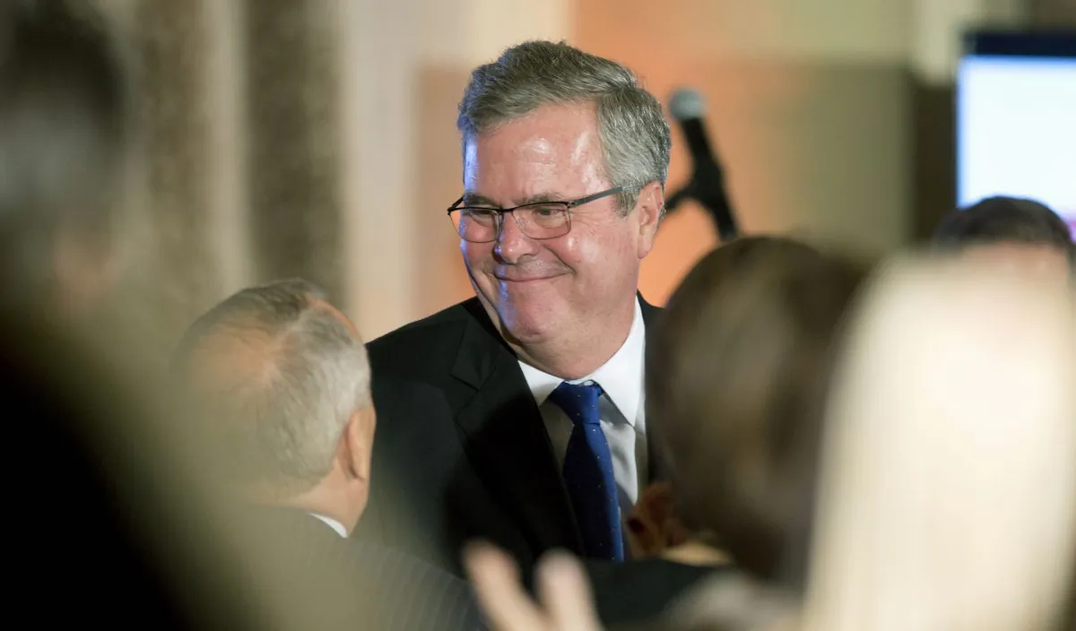 Former Florida Gov. Jeb Bush talks to supporters after speaking at the US Cuba Democracy PAC's 11th Annual Luncheon in Coral Gables, Fla., Tuesday, Dec. 2, 2014. As governor of Florida, Bush oversaw a diverse state that is home to three-quarters of the nation's estimated 2 million Cuban-Americans. His longstanding support for the US trade embargo against Cuba would provide a marked contrast with Democrat Hillary Clinton in 2016, if both decide to run for president. (AP Photo/J. Pat Carter)