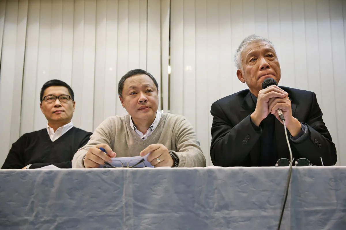 Three protest leaders, from left, Chan Kin-man, Benny Tai Yiu-ting and Chu Yiu-ming, attend a news conference in Hong Kong Tuesday, Dec. 2, 2014 as they announce that they will surrender to police. (AP Photo/Kin Cheung)