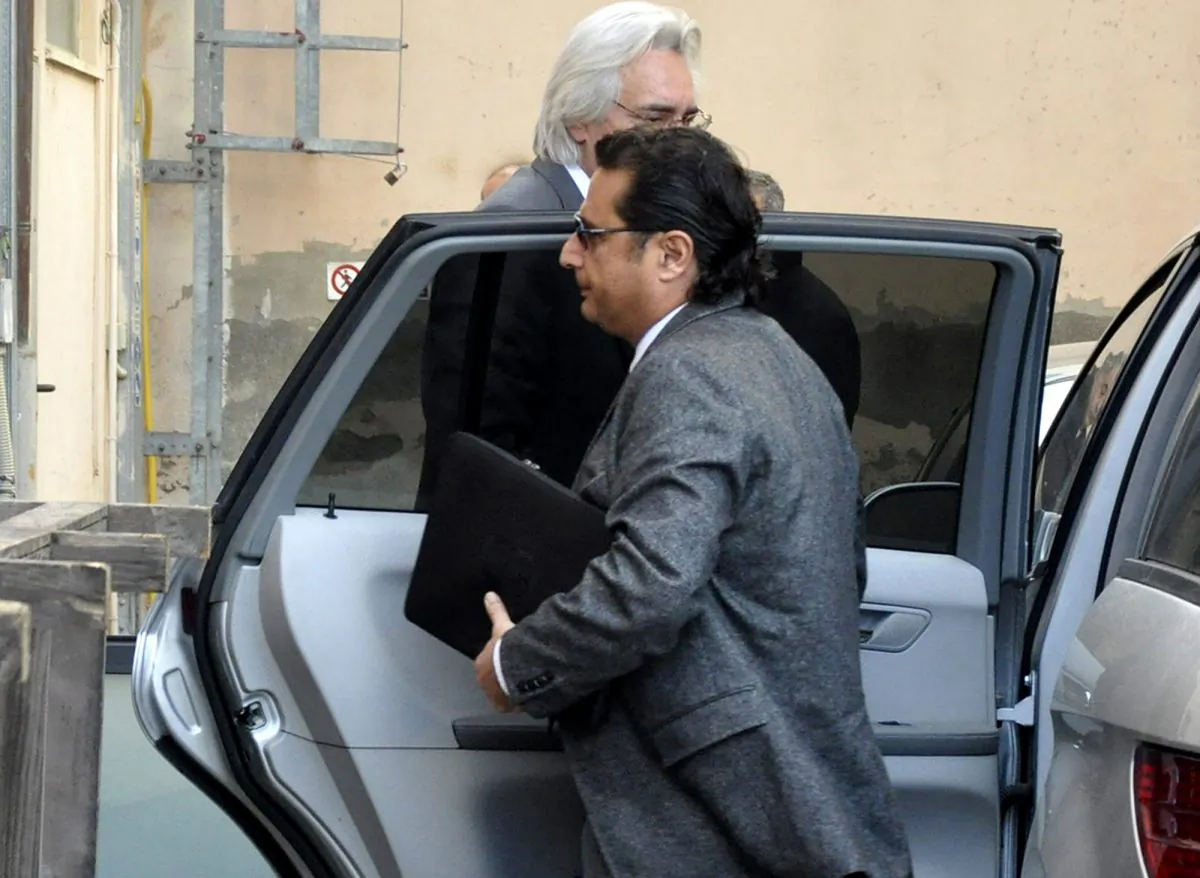 Francesco Schettino arrives to offer his first court testimony about the 2012 shipwreck off an Italian island that killed 32 people, in Grosseto, Italy, Tuesday, Dec. 2, 2014. The captain of the Costa Concordia cruise ship offered his first court testimony Tuesday about the 2012 shipwreck off an Italian island that killed 32 people, sitting hunched behind a table on a theater's stage while prosecutors questioned him from the first row. While Francesco Schettino has long said he looked forward to his day in court to vindicate himself, he was granted a request not to have his image, and only his voice, broadcast from the theater that has served as a courtroom due to the widespread interest in the case. Schettino is being tried alone on charges of manslaughter, causing a shipwreck. (AP Photo/Giacomo Aprili)