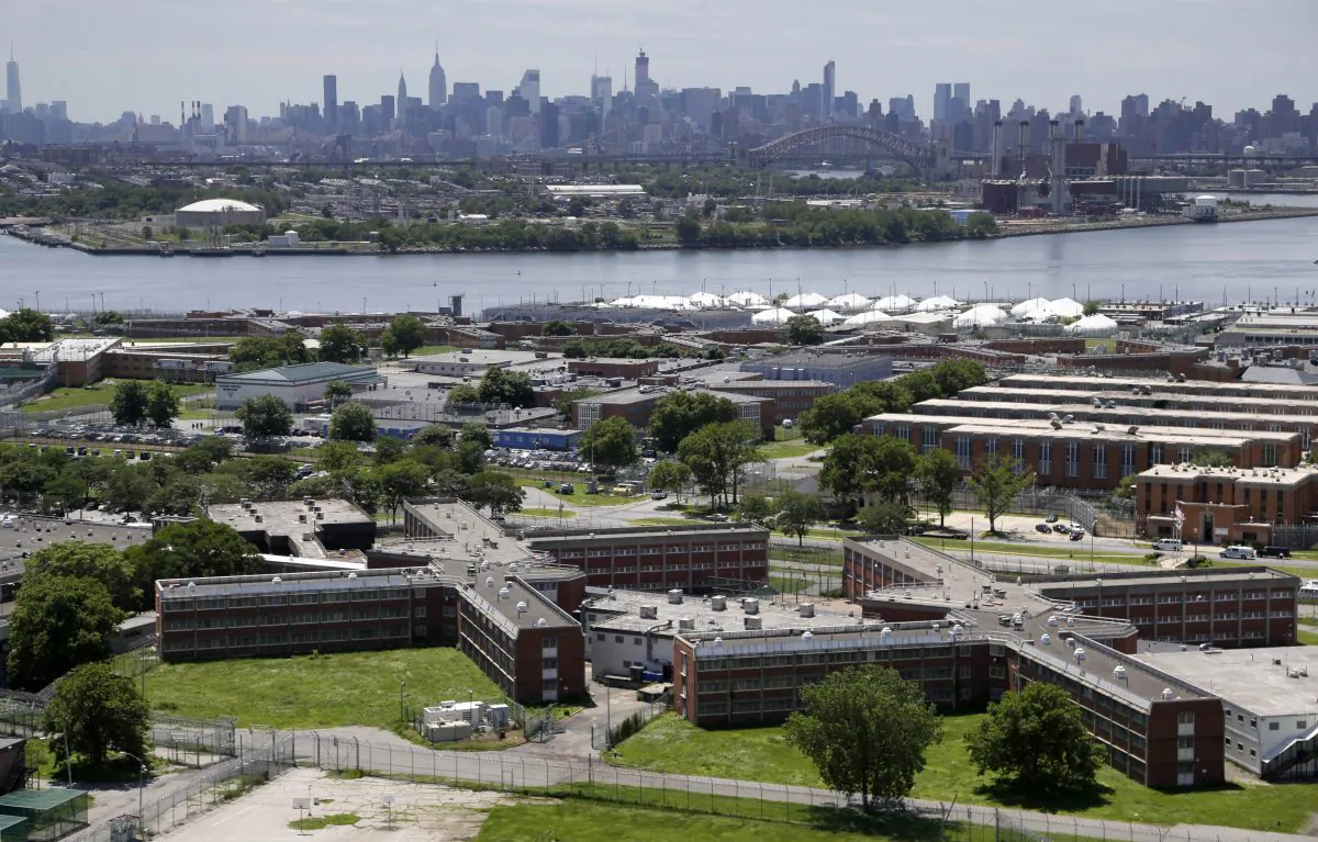 The Rikers Island jail with the New York skyline in the background on June 20, 2014. New York Mayor Bill de Blasio plans to announce his $130 million, four-year plan to overhaul how the nation’s most populous city deals with mentally ill and drug-addicted suspects, diverting many to treatment instead of jail. (AP Photo/Seth Wenig)