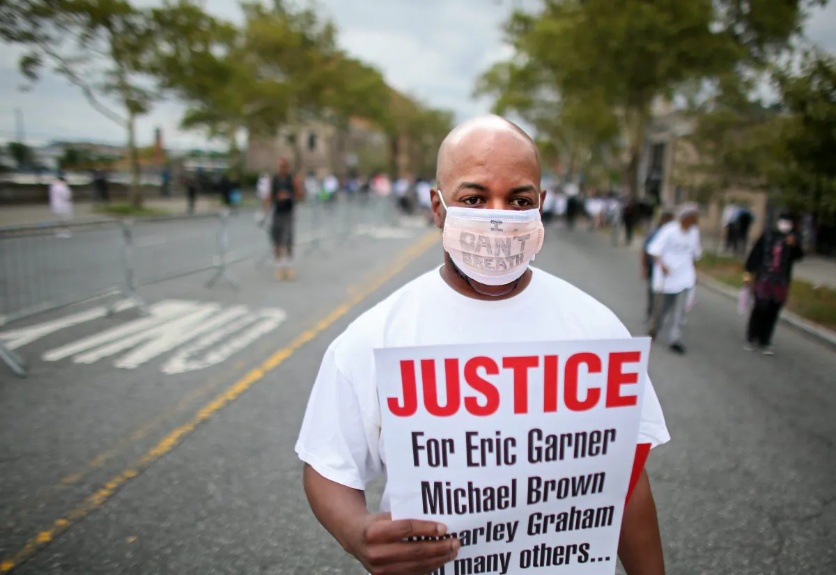 The son of Eric Garner, the man who died after being placed in a chokehold by an NYPD officer in July, said there’s going to be no riots in New York City. Al Smoot marches during a rally on Staten Island, N.Y., on Aug. 23, 2014 following the death of Eric Garner as a result of an apparent chokehold by an NYPD officer. The NYPD is preparing for potential protests ahead of a Staten Island grand jury decision whether to indict a police officer in the death of Eric Garner. (Yana Paskova/Getty Images)